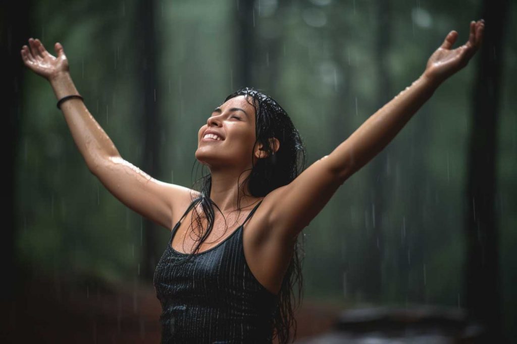 woman dancing in rain forest